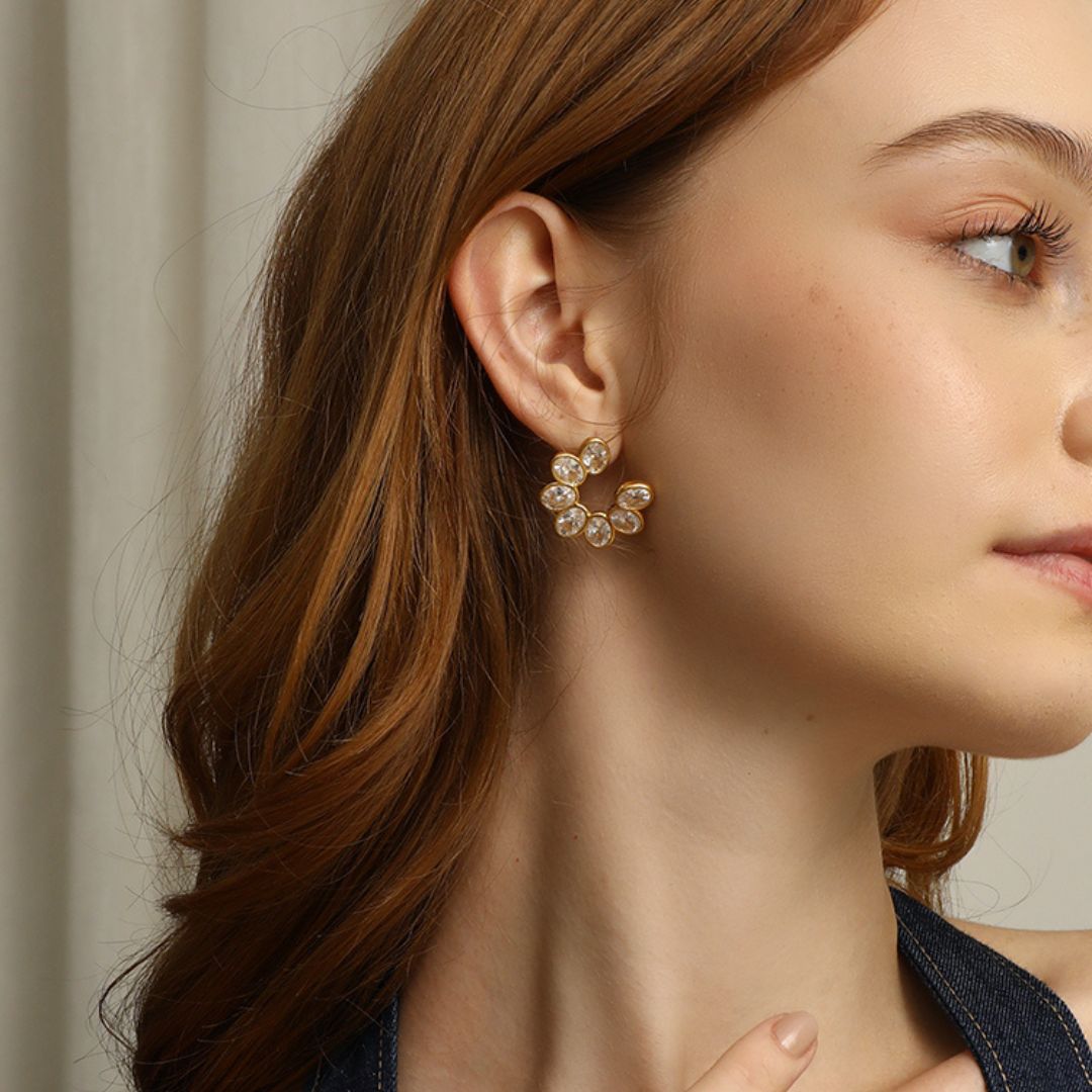 Aurélia hoop earrings featuring a cluster of oval-cut cubic zirconia stones set in a petal-inspired design