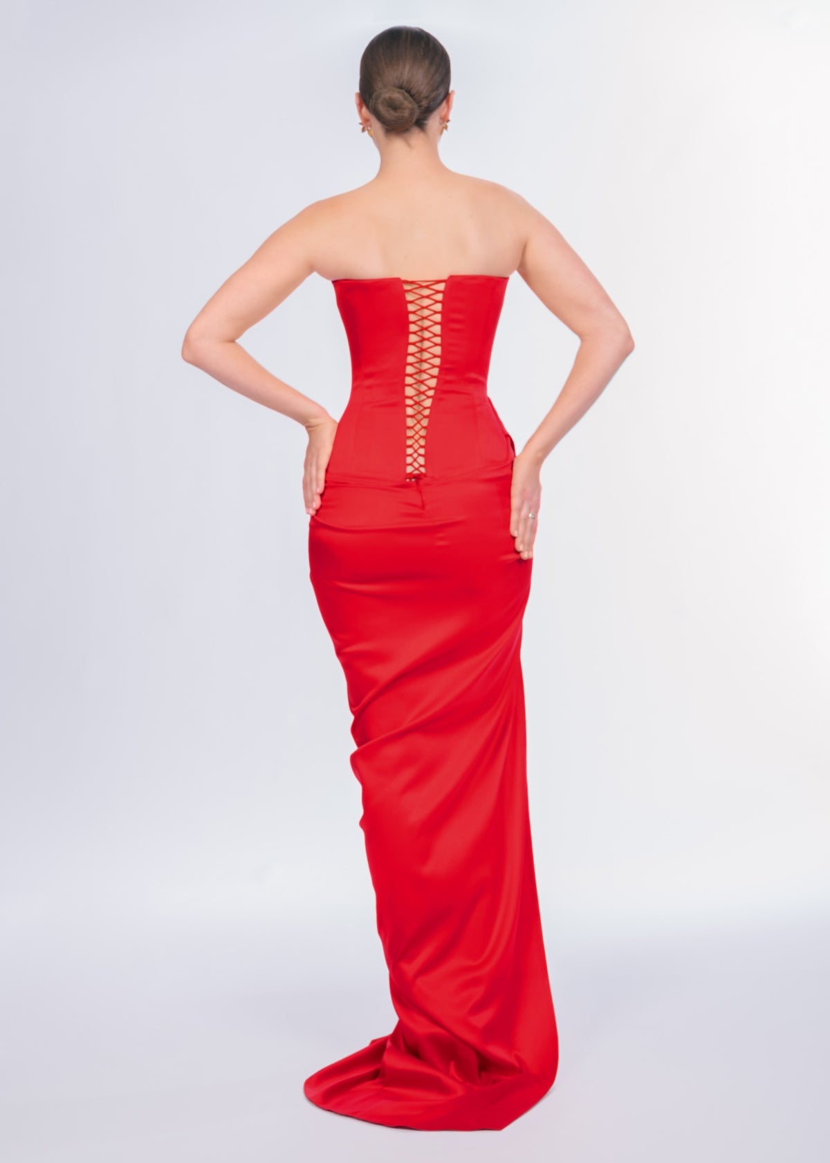 Red strapless gown with a back detail on a white background